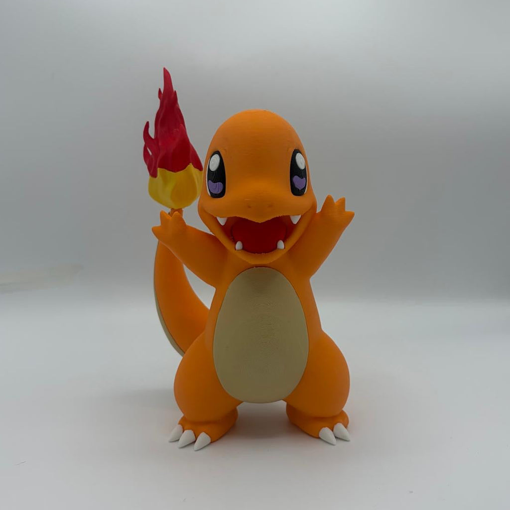 A Charmander figurine standing on a white surface against a light grey background, holding a red and yellow flame in one hand. The figure has an orange body, a cream-coloured belly, and purple eyes.