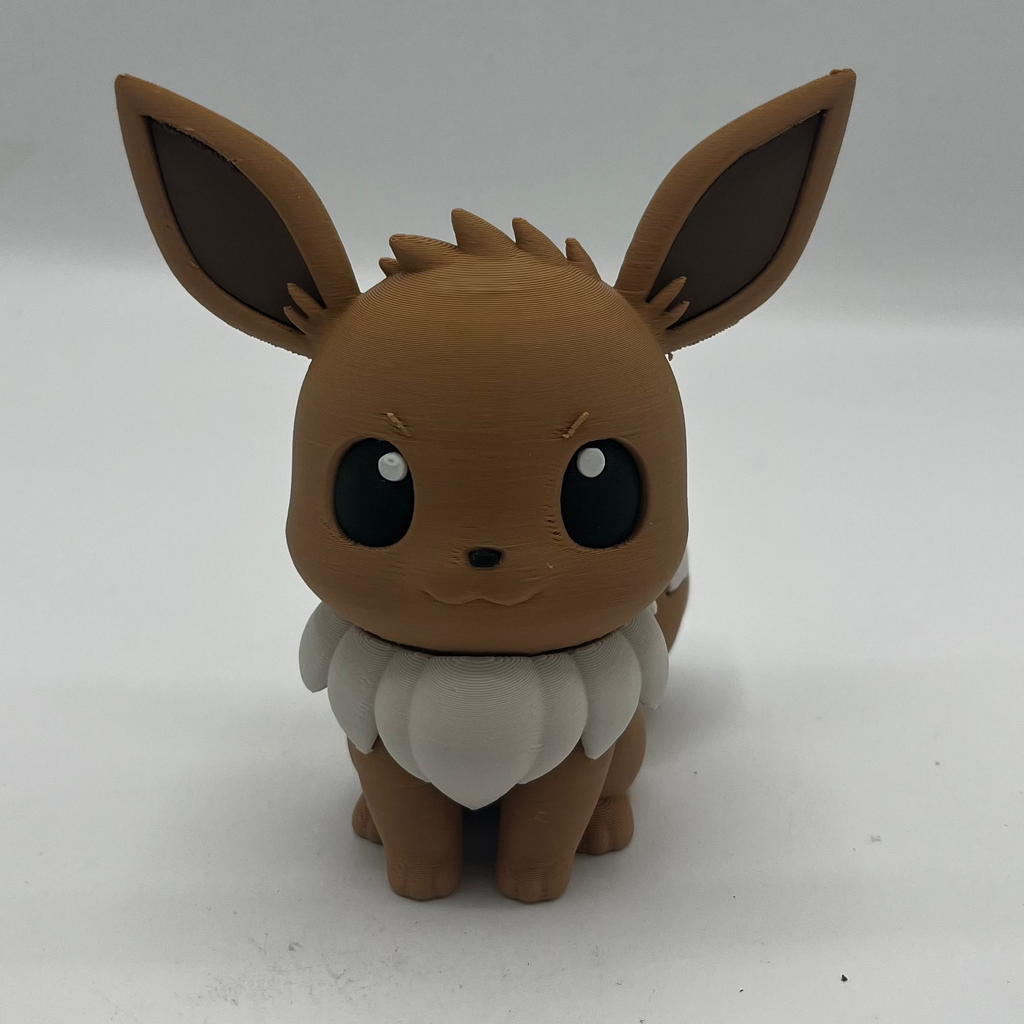 A small brown and white Eevee figurine standing against a plain light background.