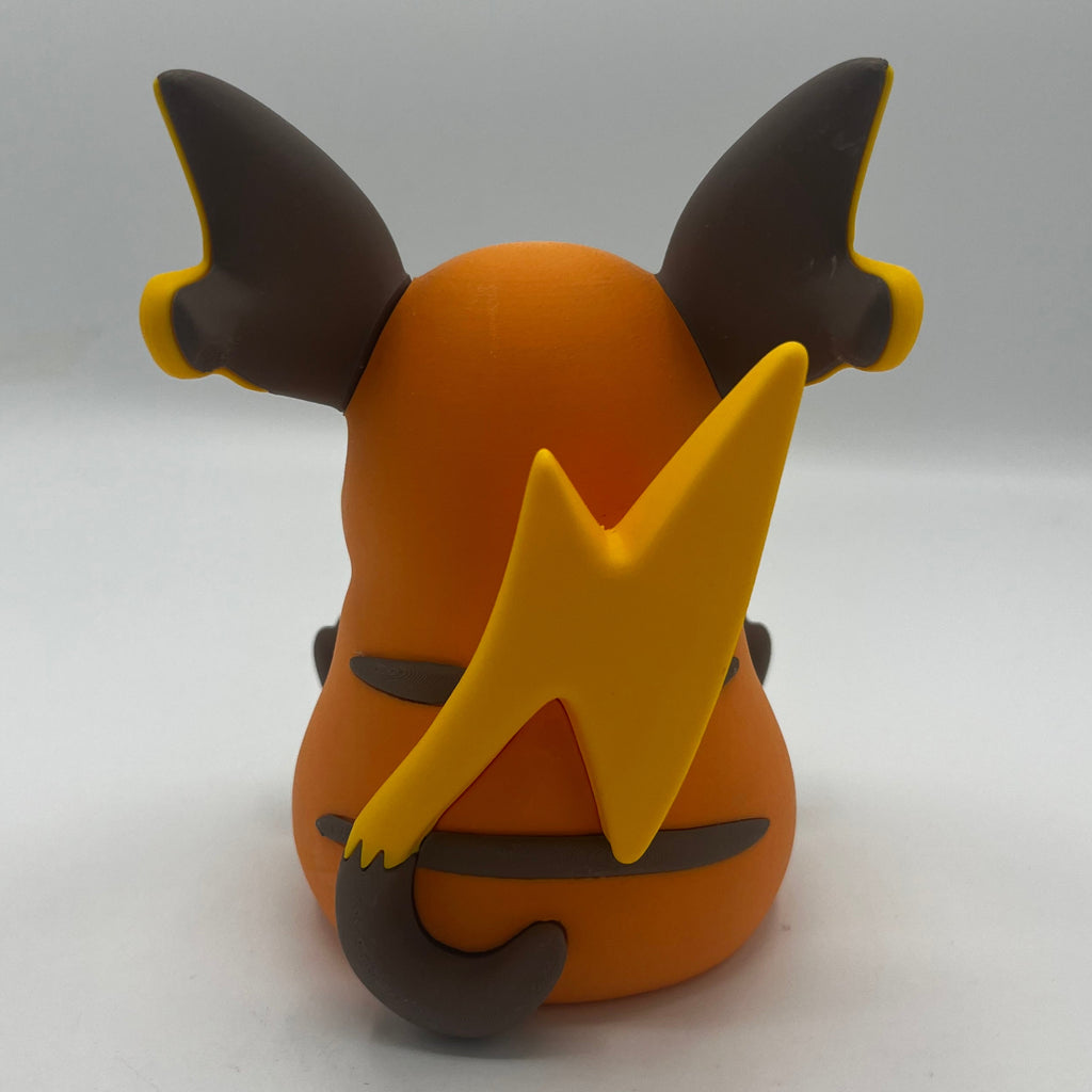 An orange and yellow clay figure of a Pokémon character, shown from the back against a plain light gray background.