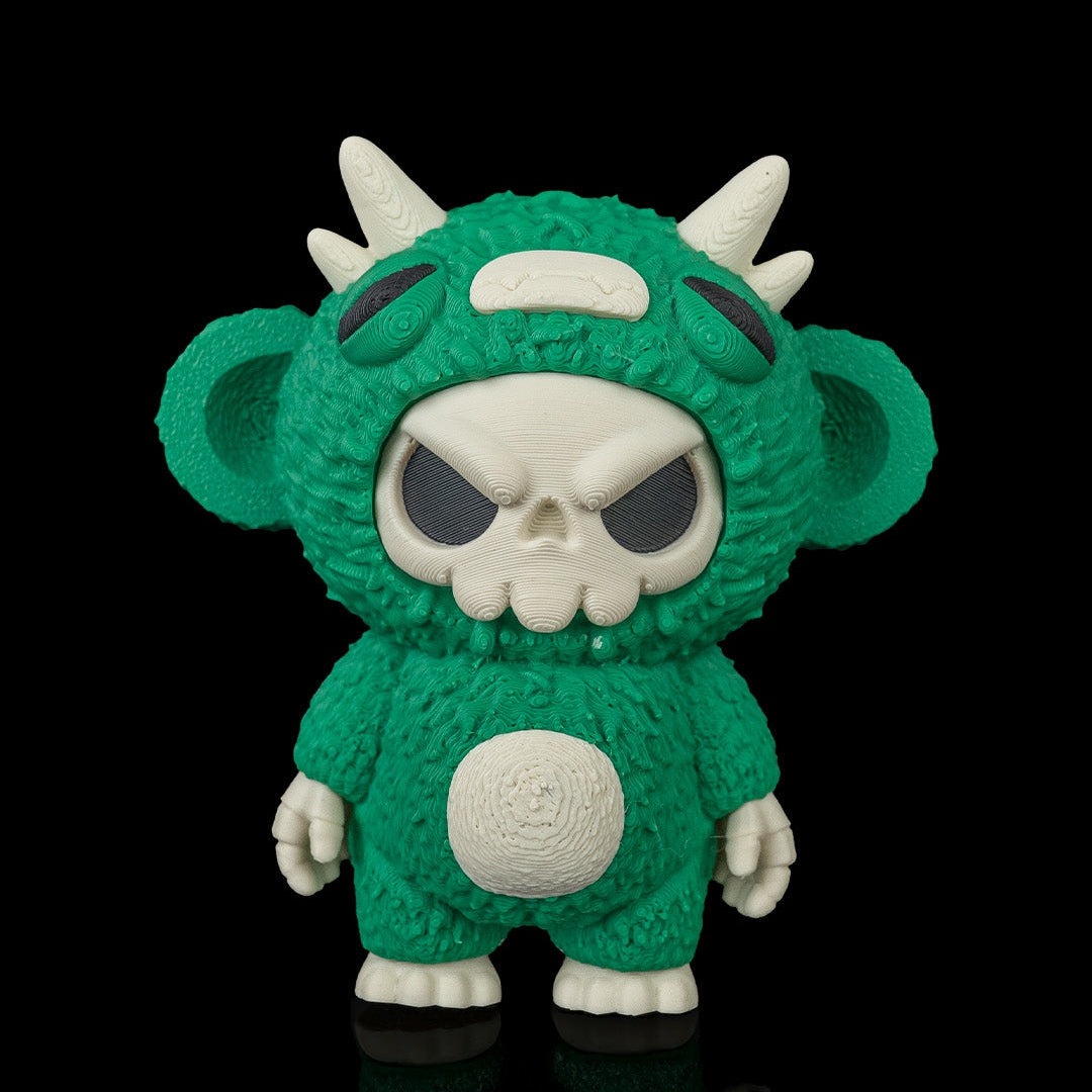 A green monster 3D printed toy with a white skull face, large ears, and white horns, standing against a solid black background.