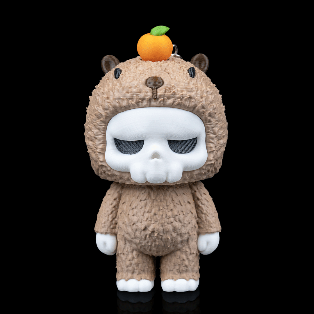 Toy figure with skull face and bear costume on a black background