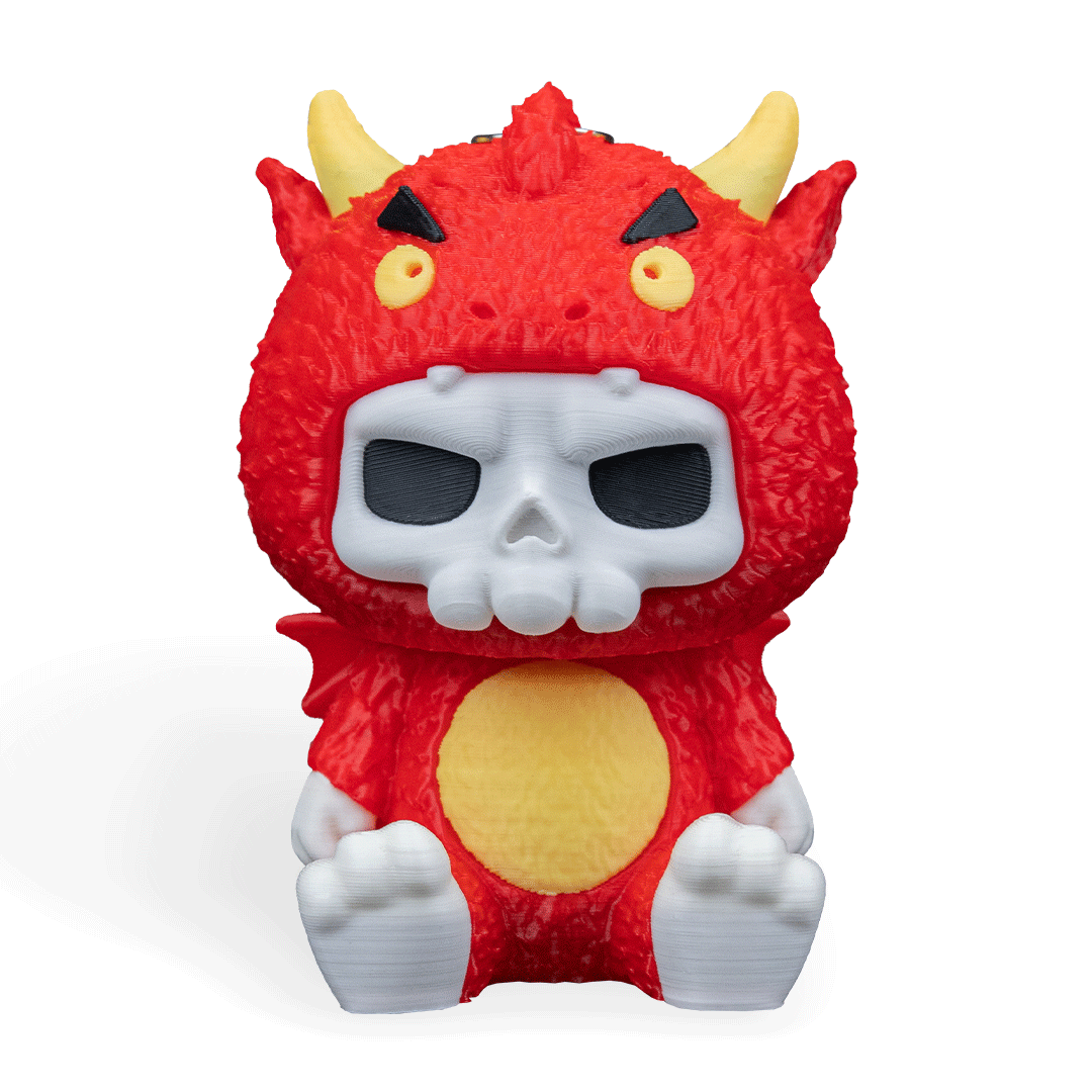 Red monster toy with skull face on a white background